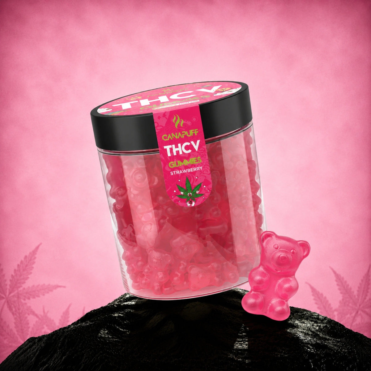 Gummies Canapuff THCv al gusto fragola in barattolo trasparente con coperchio nero ed etichetta rosa su sfondo rosa